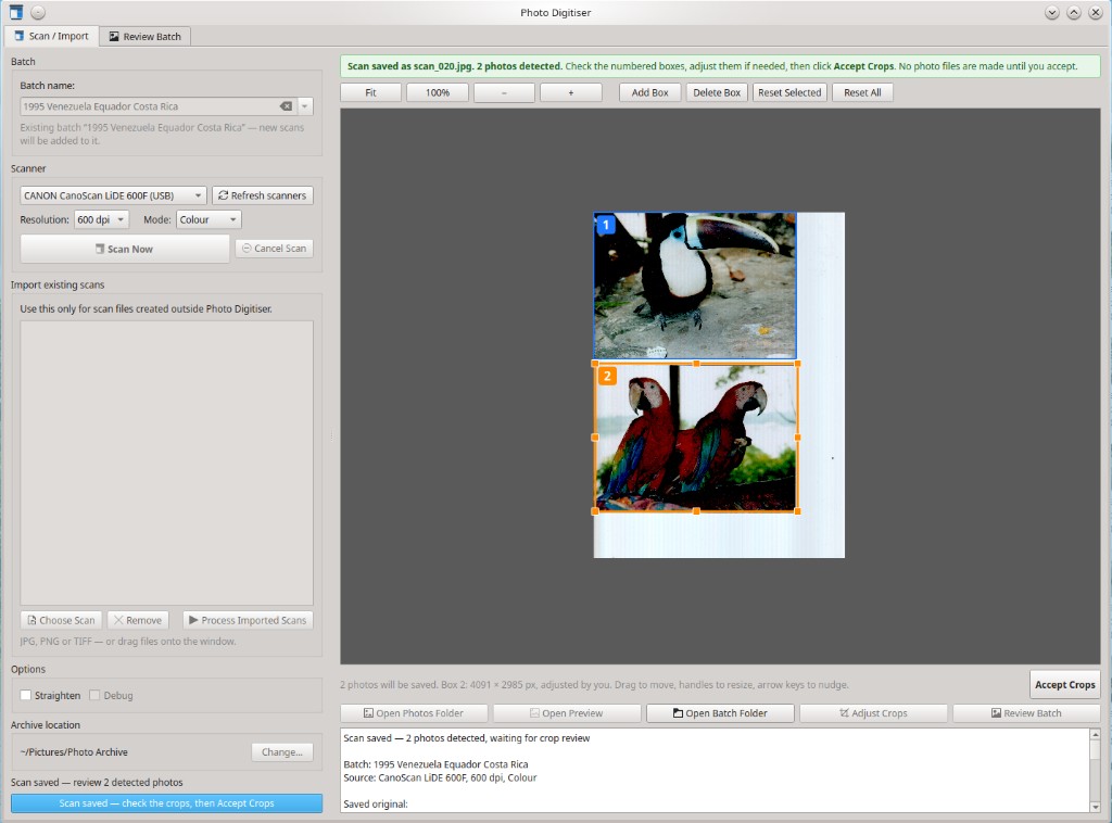Photo Digitiser desktop app showing a scan with two photos detected and outlined as numbered crop boxes, ready for review before saving